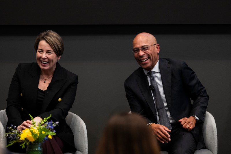 Maura Healey and Deval Patrick smiling and laughing.