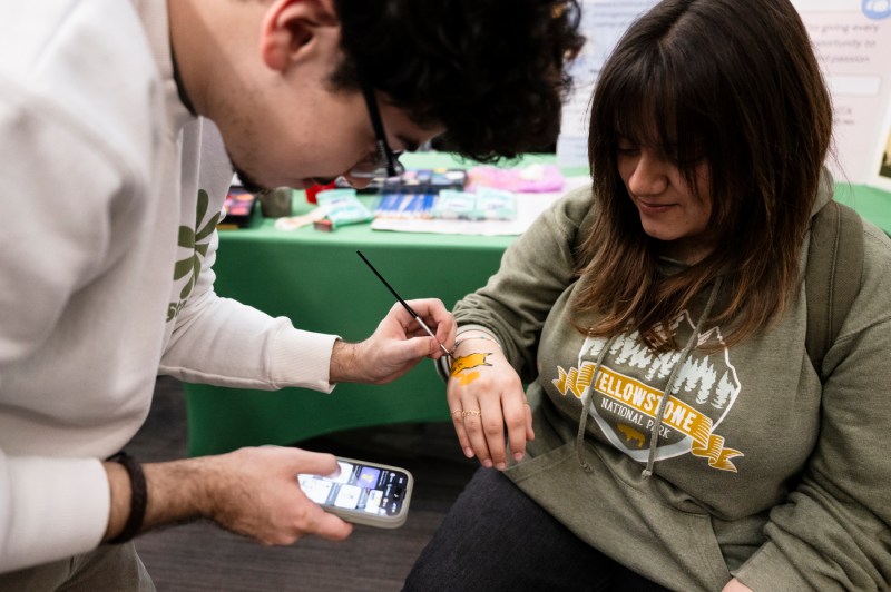 A person getting their hand painted at Giving Day.