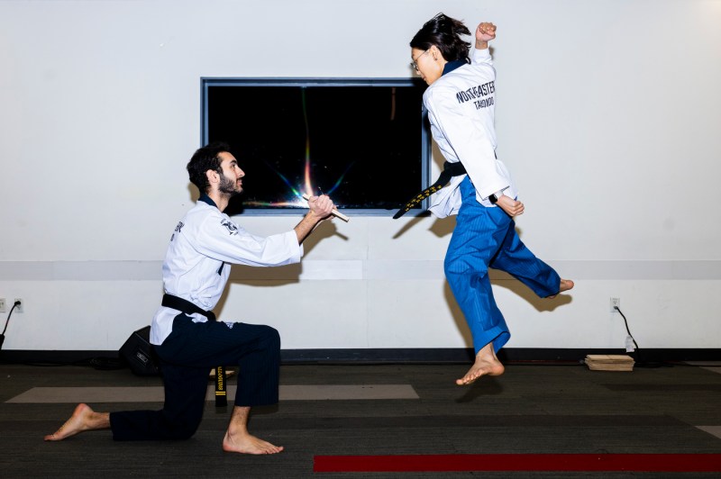 A person karate chopping a board at Giving Day.