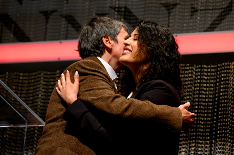 Two people hugging at Blackman auditorium. 