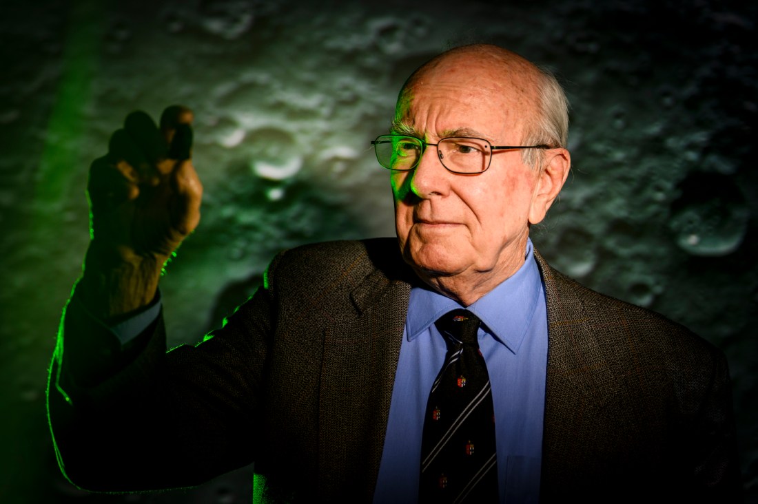 Robert Lowndes holding up a moon rock.