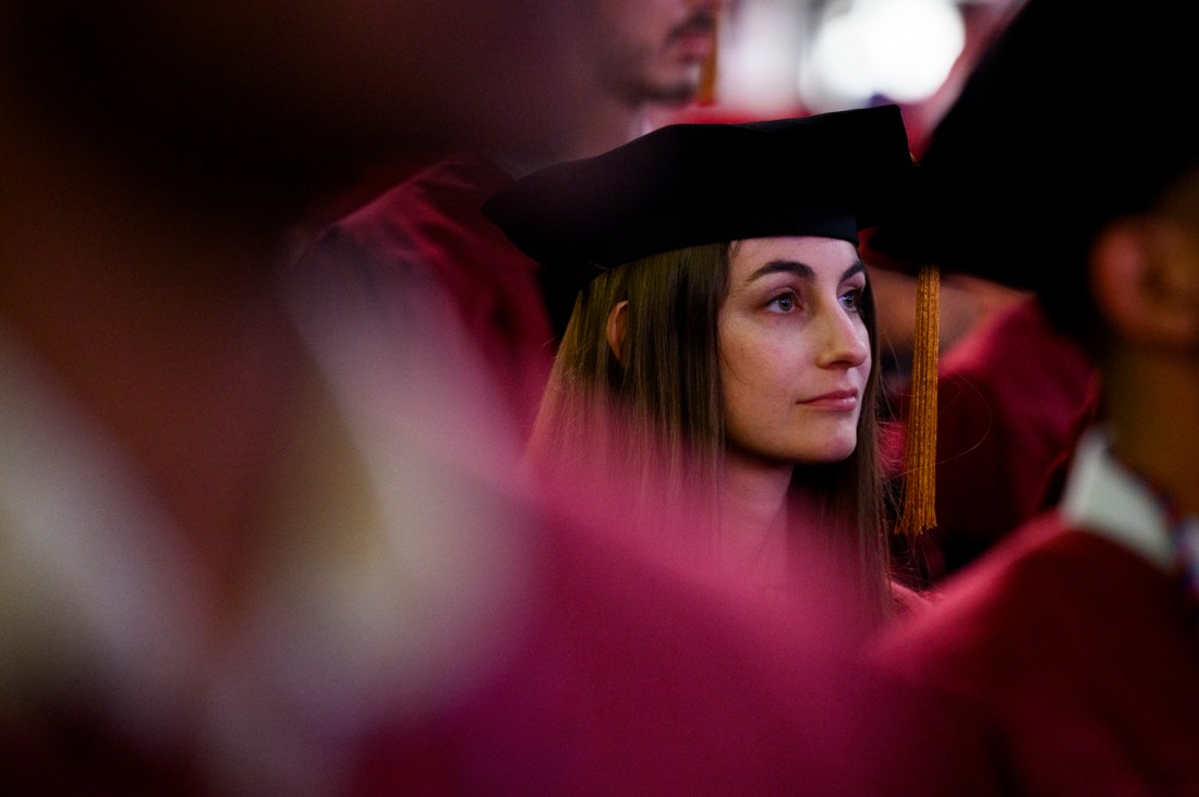 A graduate listening at the Doctor of Philosophy Hooding.