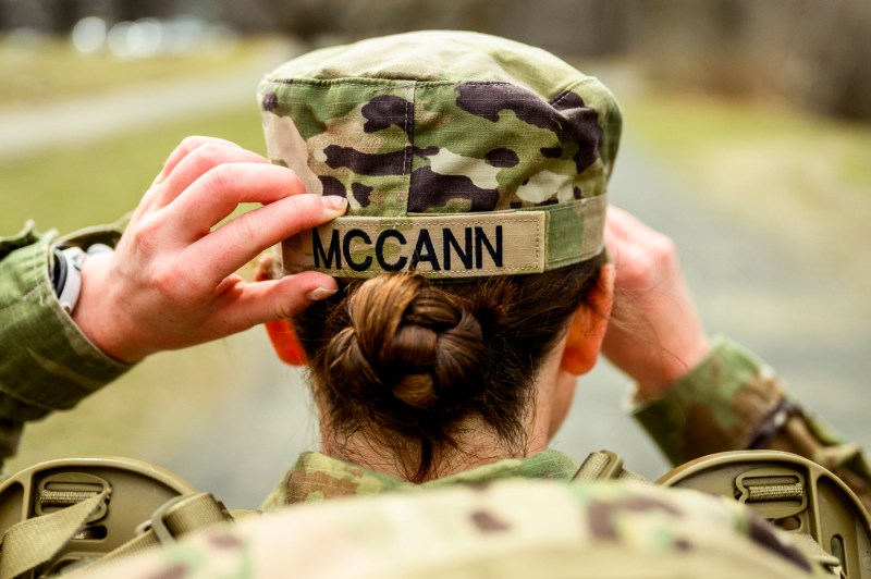 Kayla McCann adjusting her military hat.
