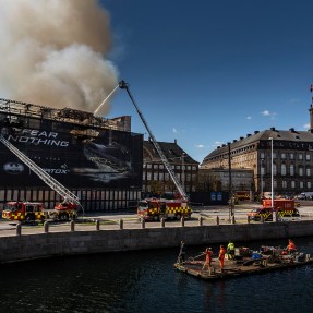 Firefighters spraying water on the Old Stock Exchange in Copenhagen.