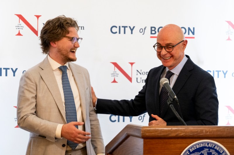 A Moakley scholar and President Joseph Aoun laughing together.