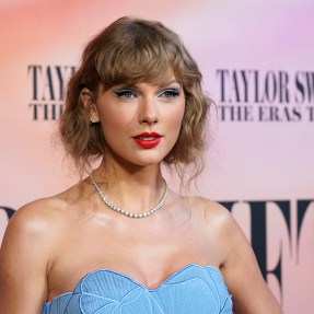 Taylor Swift at the premiere of the Eras Tour concert film wearing a blue dress.