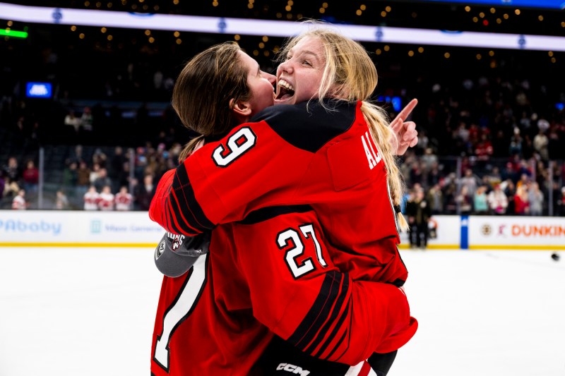 Megan Carter hugging a fellow hockey player. 