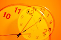 A photo of a clock with an orange overlay.