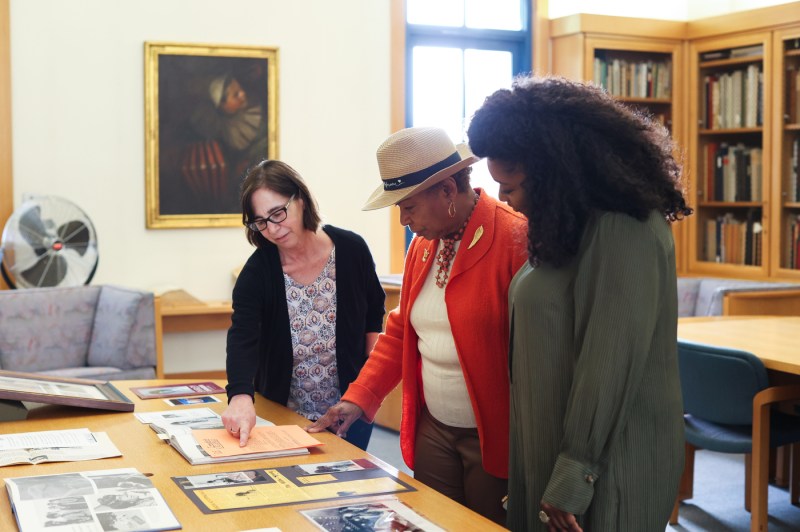 U.S. Rep Barbara Lee and Christina Jackson looking at archives with another person.