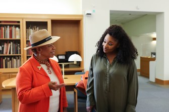 U.S. Rep. Barbara Lee and Christina Jackson talking to each other on the Oakland campus.
