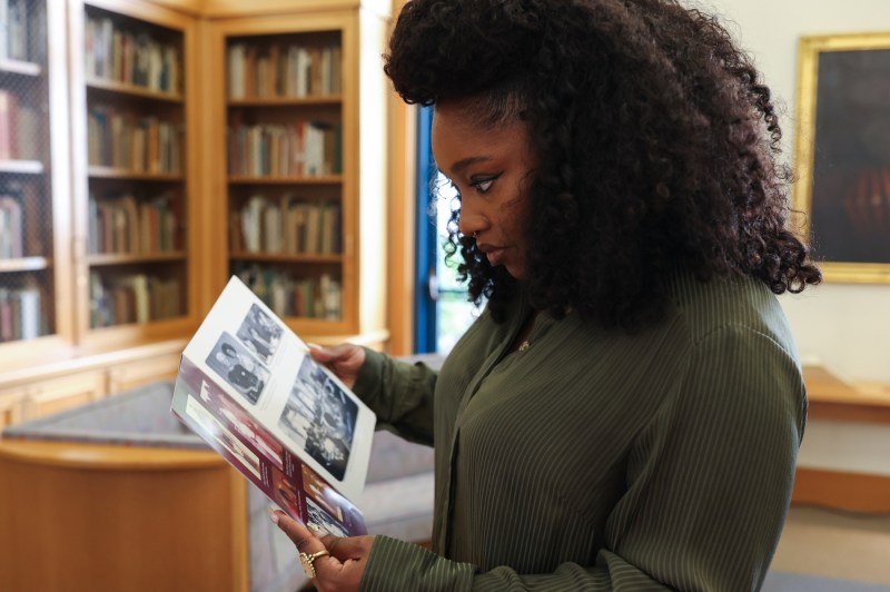Christina Jackson looking through a book of photographs.