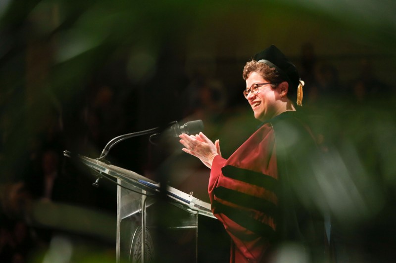 Dr. Carmen Sceppa clapping at the Bouve commencement ceremony.