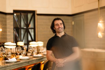 Headshot of Eric Papachristos in La Padrona Italian restaurant.
