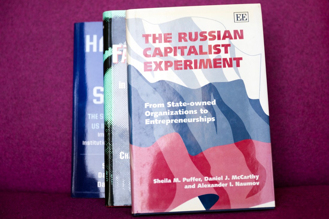 A stack of books by Sheila Puffer, 'The Russian Capitalist Experiment' on top.