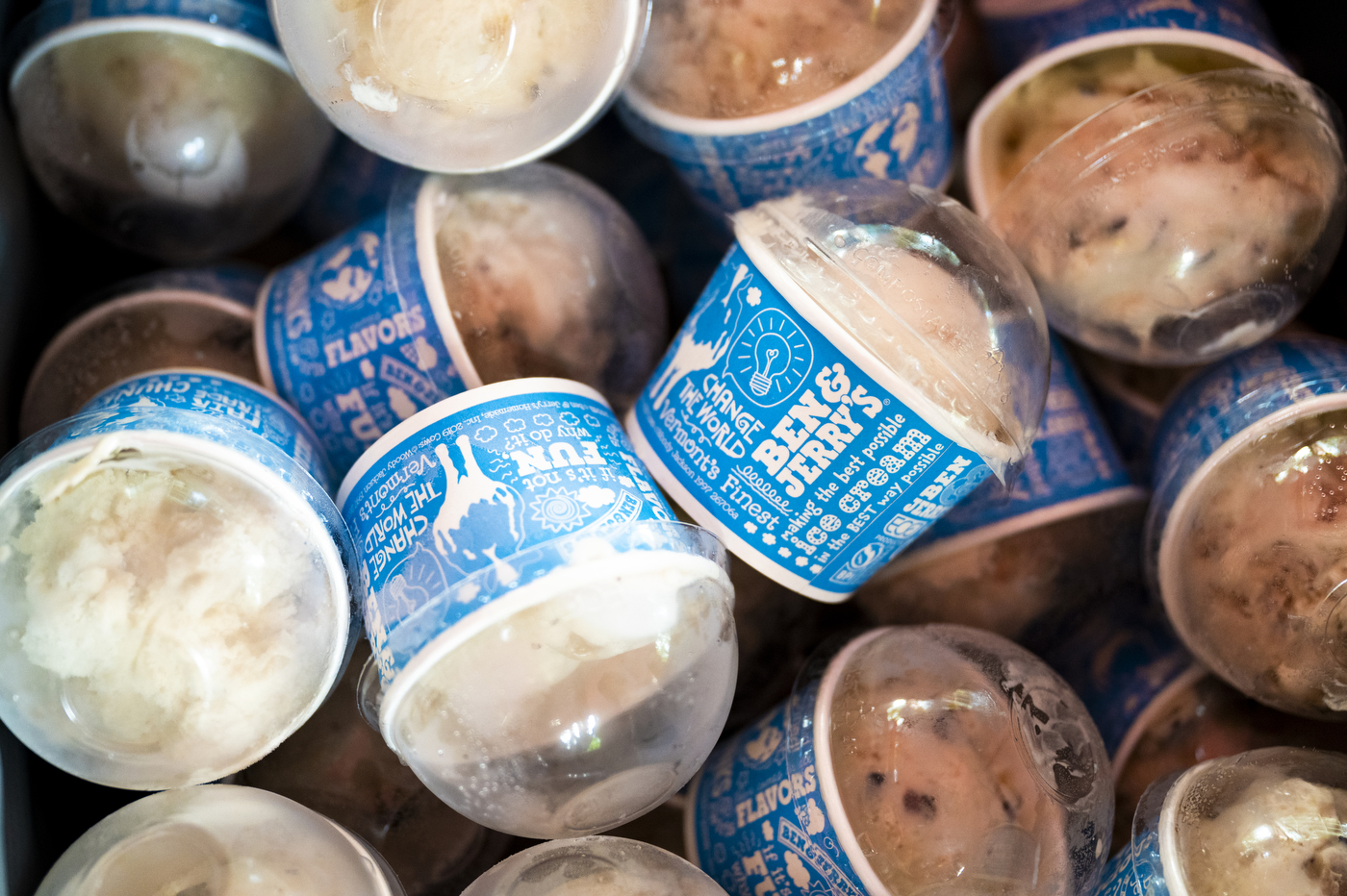 A bucket of different flavored ice cream. 