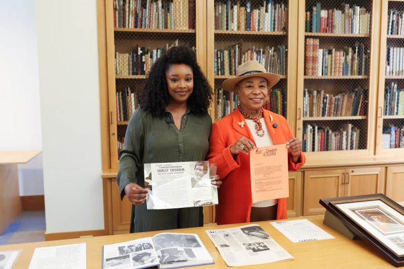 U.S. Rep Barbara Lee and Christina Jackson posing together in front of shelves of books. 