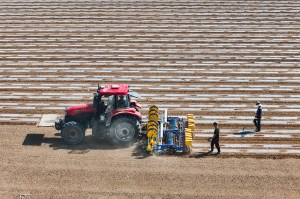 A tractor driving across a field in China.