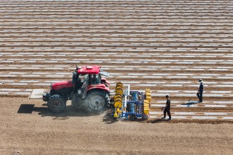 A tractor driving across a field in China.