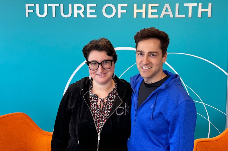 Valerie and Codi Gharagouzloo in front of a blue wall that says 'Future of Health' on it.
