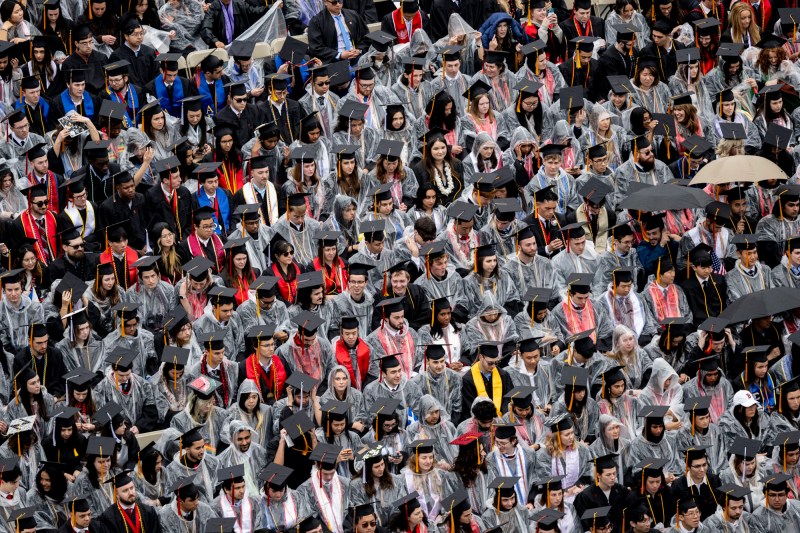 Graduates in regalia and rain ponchos during the ceremoney