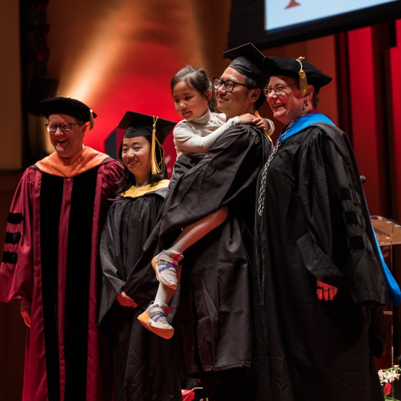 Three cheers for husband, wife — and their 5-year-old daughter — at Northeastern’s Seattle commencement