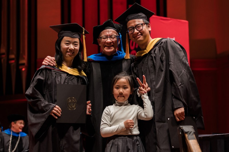 Qingzhao Li and Wen Min posing at Seattle commencement with their daughter Camila.