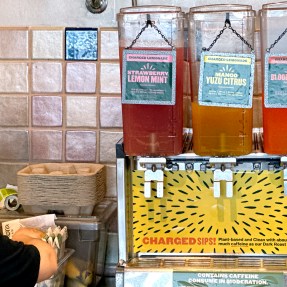 A fountain station of Panera's ‘Charged Lemonade’ drinks on a counter.