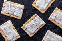 Pop tarts laid out on a dark grey surface.