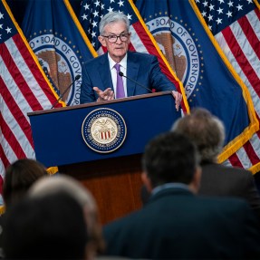 Jerome Powell at a podium during a press conference.