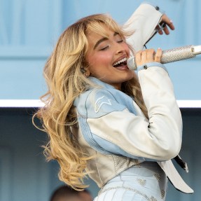 Sabrina Carpenter performs onstage while wearing a denim jacket and skirt.