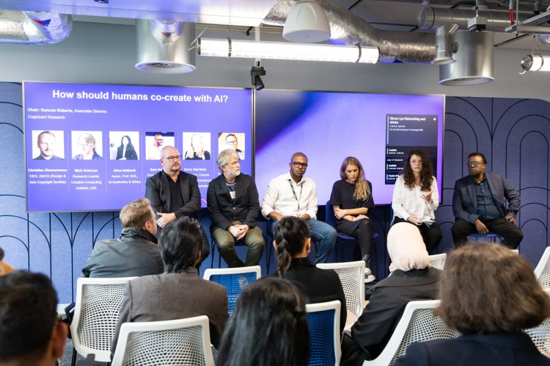 A panel of six people sitting in chairs on stage at the Adobe offices in London.