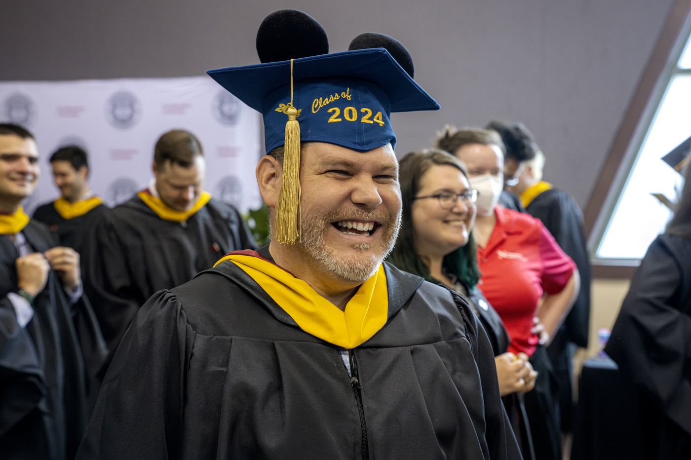 A graduate wearing a cap that has 'Class of 2024' embroidered on the front.