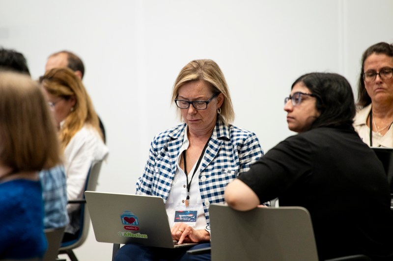 An audience member taking notes on their laptop at the Public Health Technology summit. 