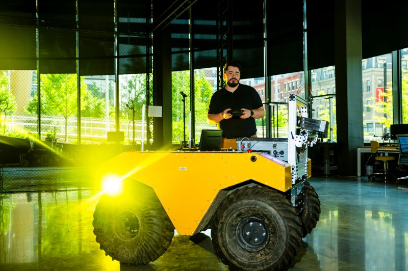 Oscar De La Garza uses a robotic controller that powers an Amazon machine.