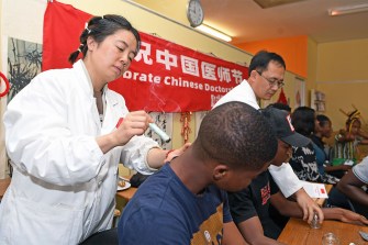 A student receiving a traditional Chinese medicine therapy.