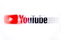 A blurred image of YouTube's business logo over a white background.