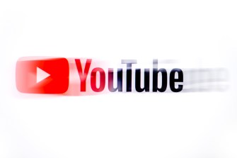 A blurred image of YouTube's business logo over a white background.