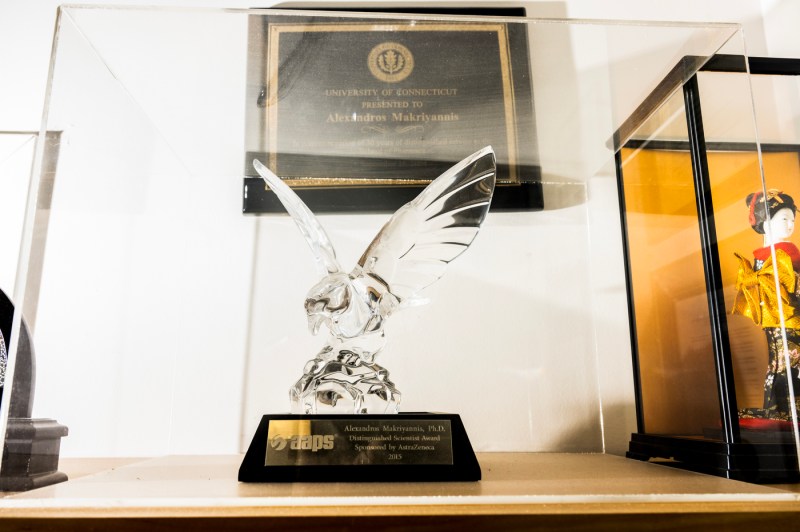 One of Alexandros Makriyannis' awards, a bird shaped glass trophy, sits in a protective display box.