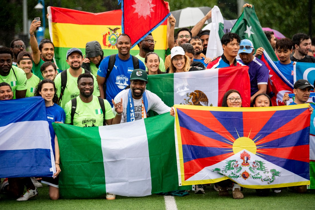 Participants in the Boston Unity Cup holding up nationality flags on Carter Field.