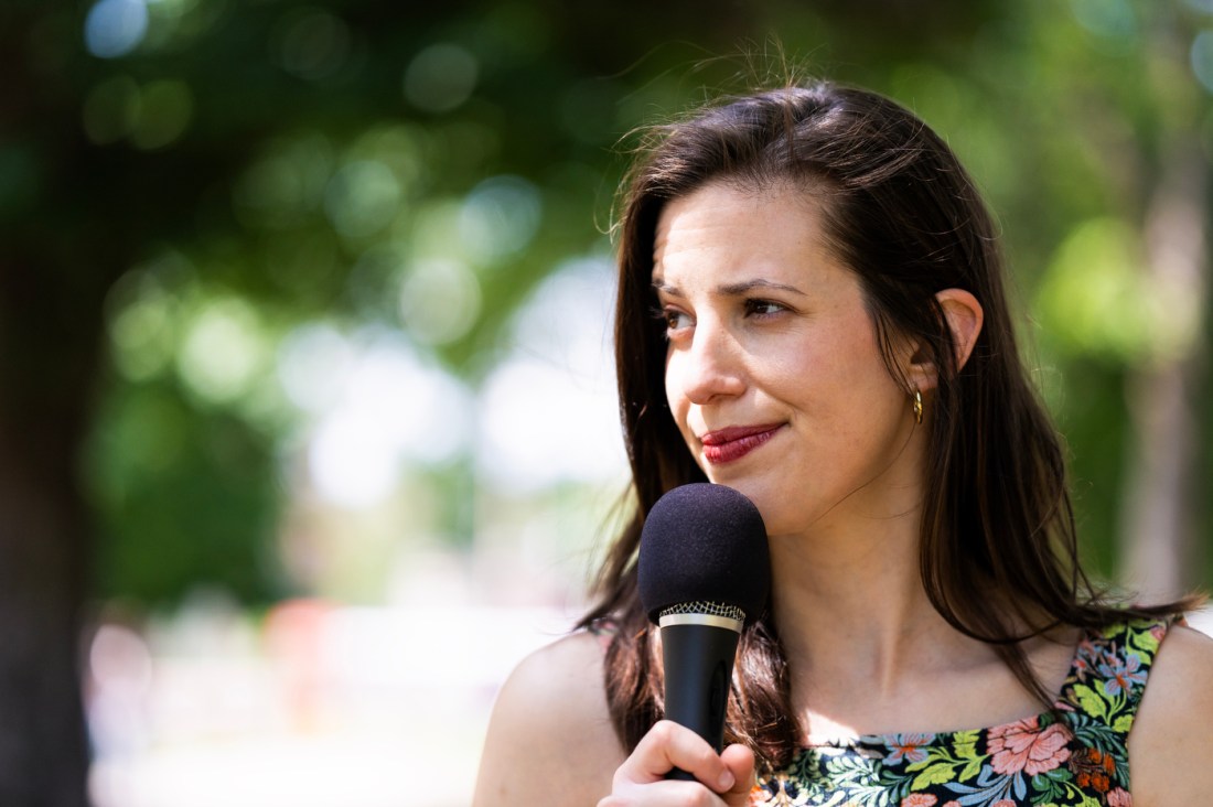 Emily Costa holding a microphone.