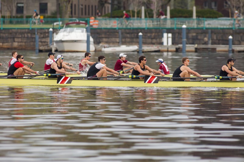 Ten athletes sit inside two different rowboats in Boston's Charles Rivers.