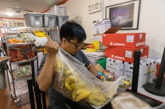 Food pantry worker organizes bananas.