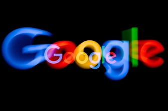The colorful Google logo is blurred on top of a black background.