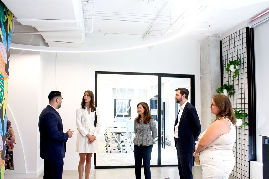 Karlie Kloss standing with a group of people at the Miami campus.