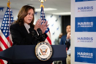 Kamala Harris gestures at a podium while speaking during her campaign.