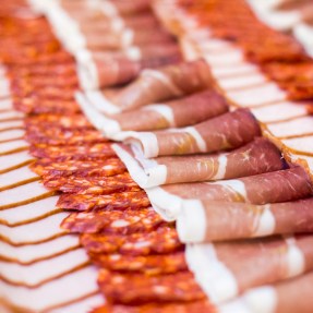 Rows of cold cut meats.