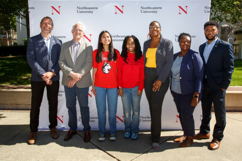 A group of people posing for a photo at the Oakland Opportunity Scholarships press conference.