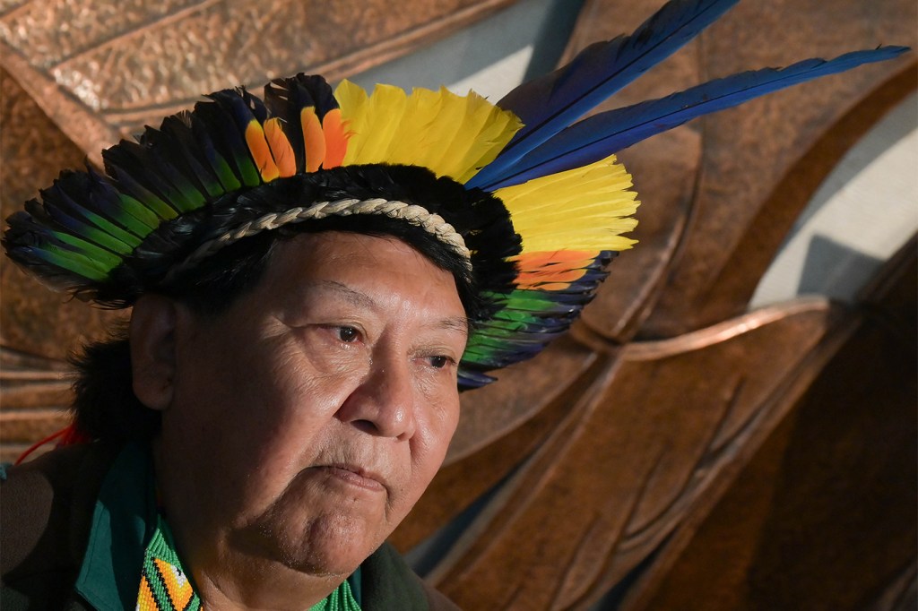 The leader of the indigenous peoples in the Brazilian Amazon wearing a traditional headdress.