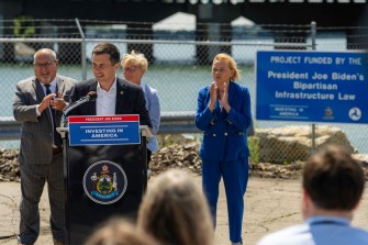 US Secretary of Transportation Pete Buttigieg speaking at a podium in Portland, Maine.