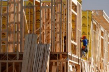 A worker building a home under construction.